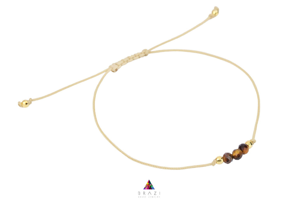 Bransoletka z kulistym tygrysim okiem na czarnym sznurku, biżuteria handmade marki Brazi