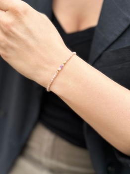 Bransoletka z kamieni naturalnych na tle ciemnej marynarki, delikatna biżuteria handmade marki Brazi.